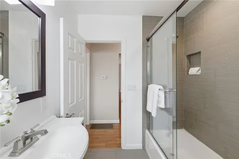 a en suite bathroom with a granite countertop sink and a mirror