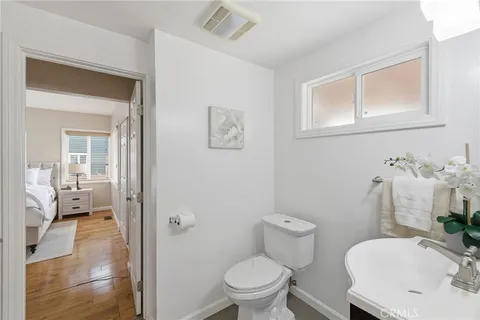 a en suite bathroom with a granite countertop sink and a mirror