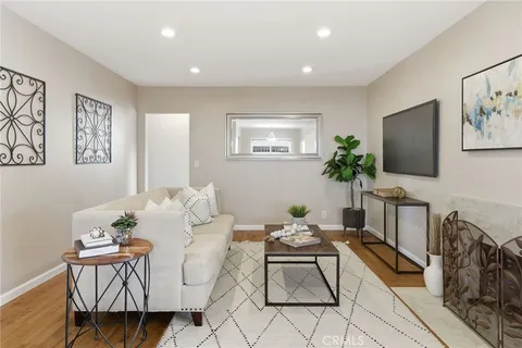 a dining room with furniture and wooden floor