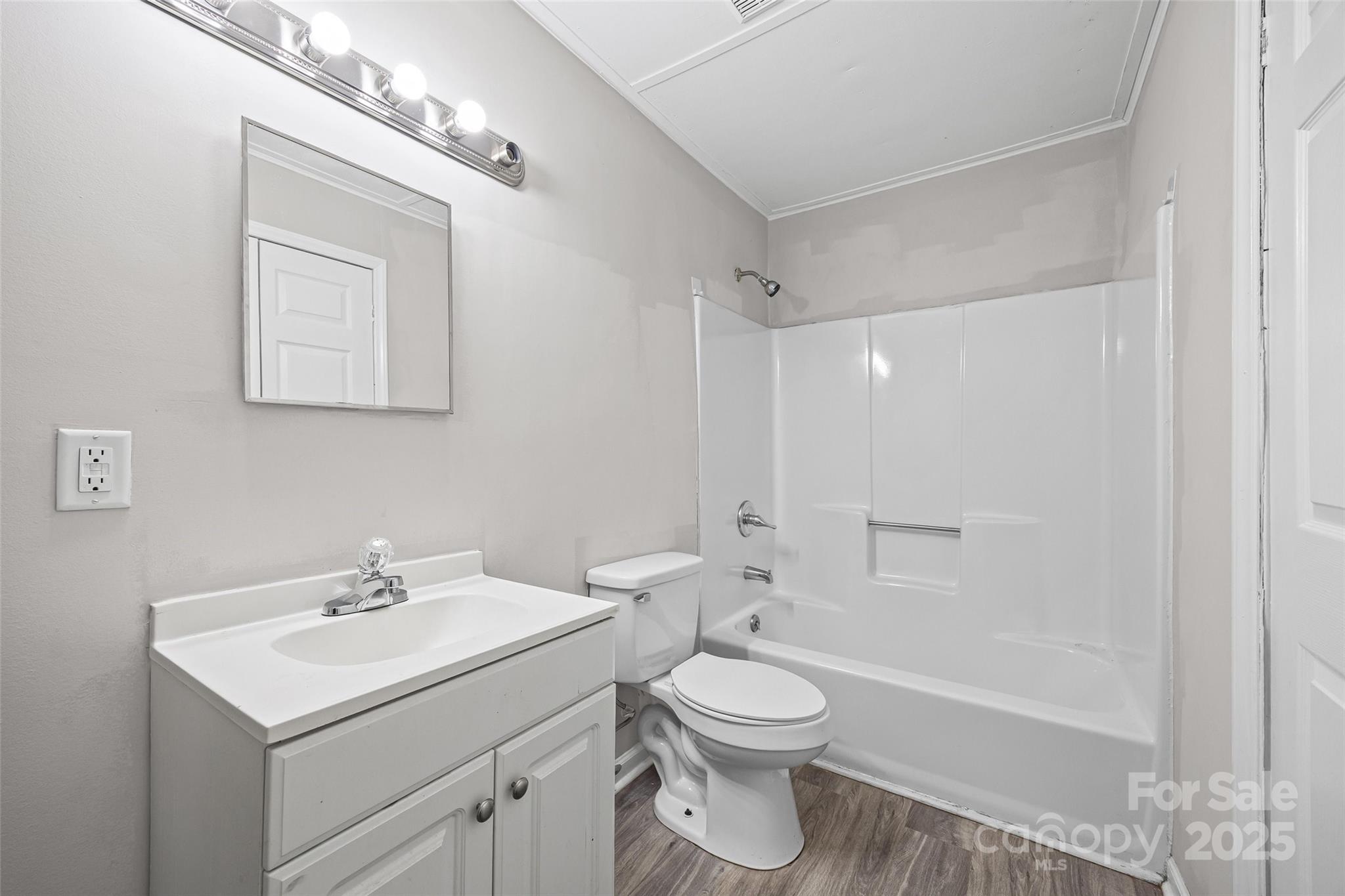 616 Simpson Street Rock Hill, SC 29730 - Photo 11 of 21 a bathroom with a toilet a sink a mirror and a bathtub