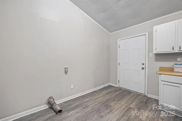 a view of a room with wooden floor