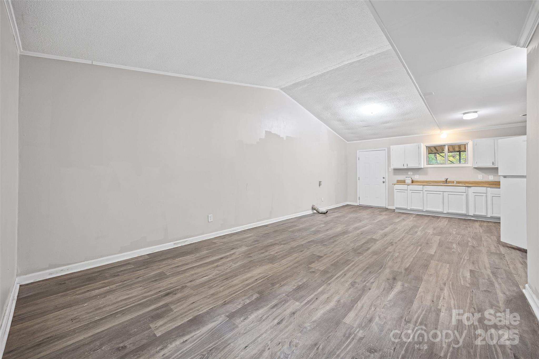616 Simpson Street Rock Hill, SC 29730 - Photo 4 of 21 wooden floor in an empty room with a kitchen