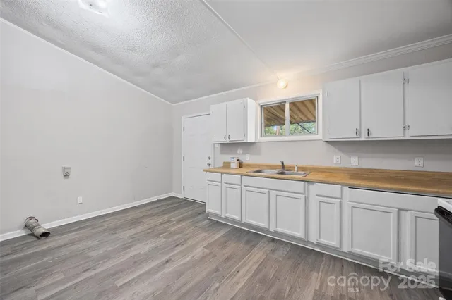 a kitchen with sink cabinets and wooden floor