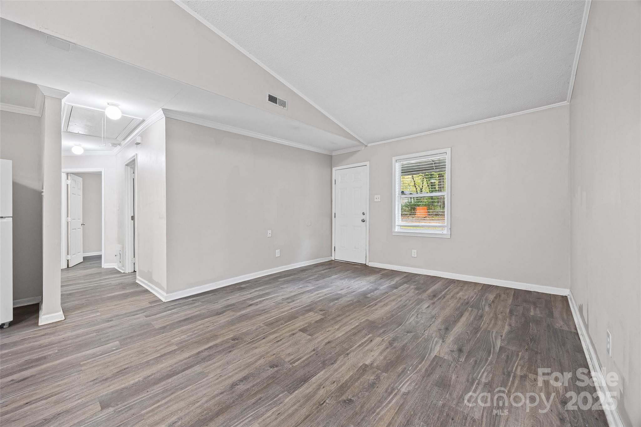 616 Simpson Street Rock Hill, SC 29730 - Photo 8 of 21 a view of an empty room with wooden floor and a window