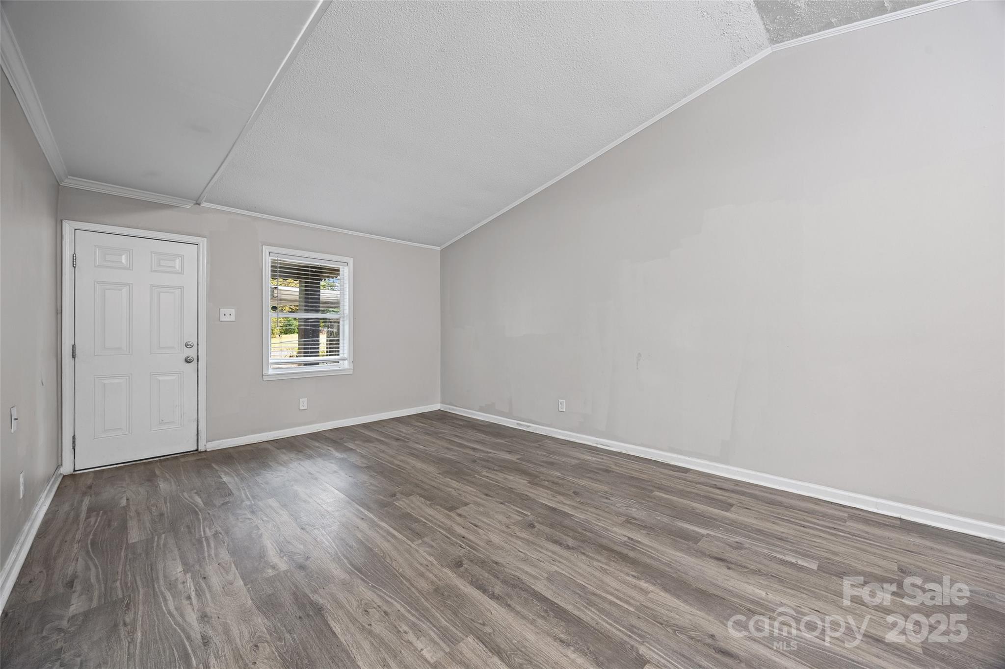 616 Simpson Street Rock Hill, SC 29730 - Photo 9 of 21 a view of an empty room with wooden floor and a window