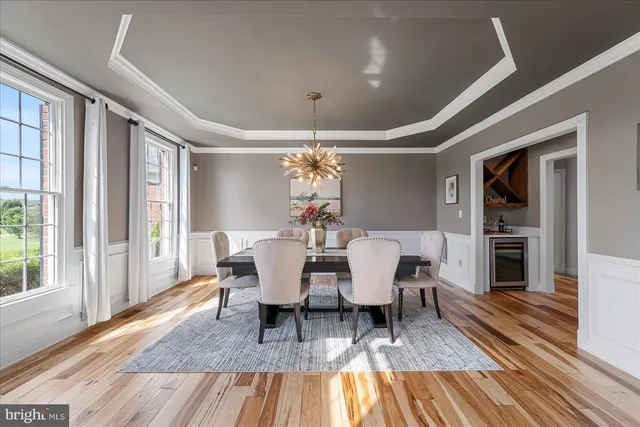 a living room with furniture a large window and a fireplace