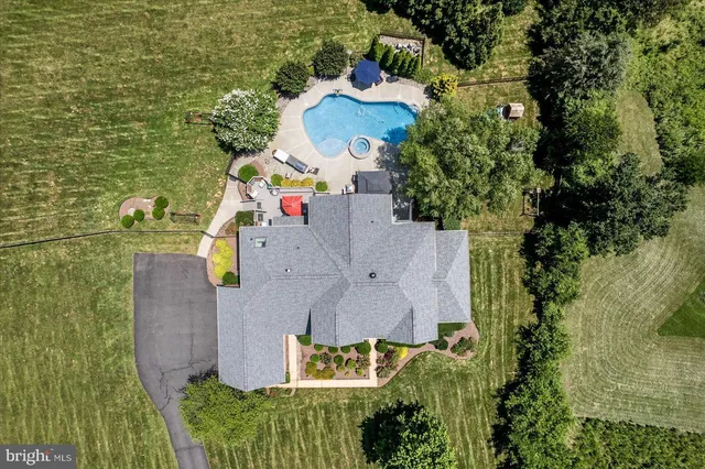 an aerial view of residential house with outdoor space and swimming pool