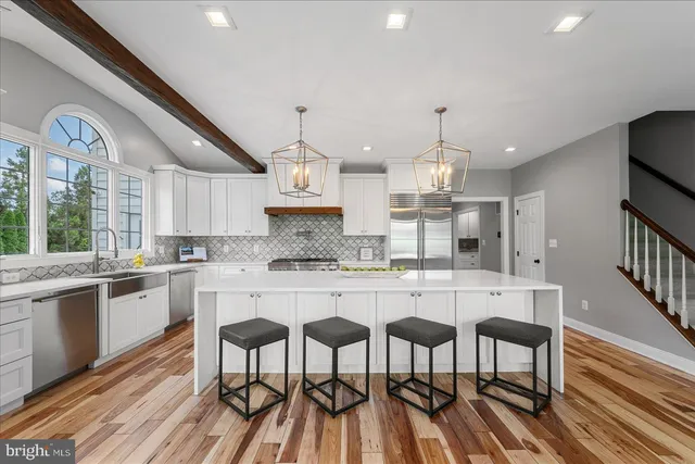 a view of hallway with a window and wooden floor