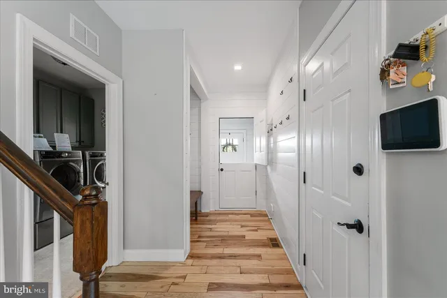a view of an entryway with wooden floor and stairs