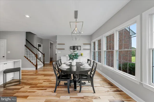 a view of a livingroom with furniture window and ceiling fan