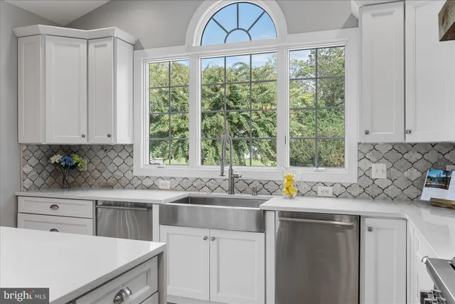 a living room with furniture a flat screen tv and a large window