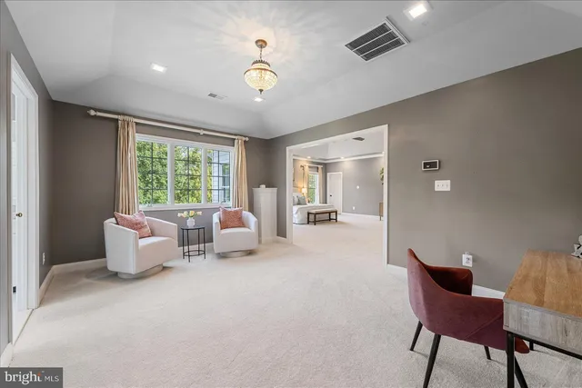 a view of a building with a big yard and large trees