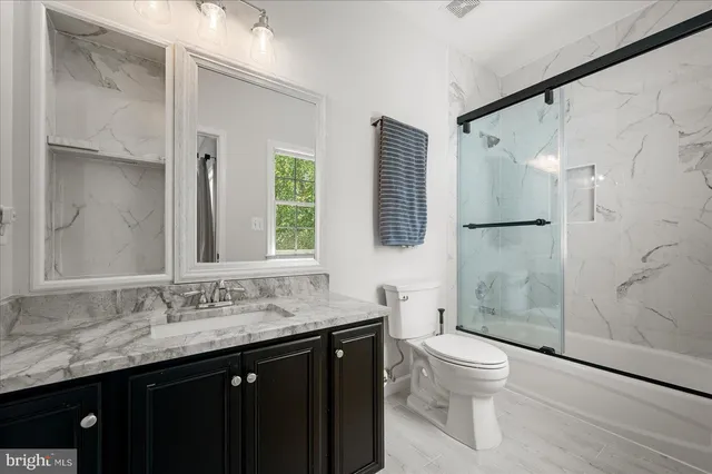 a view of a swimming pool with lawn chairs and plants