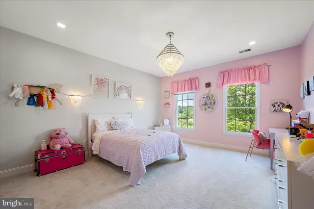 a view of a house with a big yard and large trees