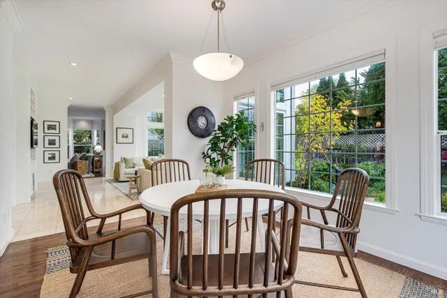 a living room with furniture large window and a fireplace