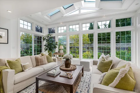 a living room with furniture and floor to ceiling windows