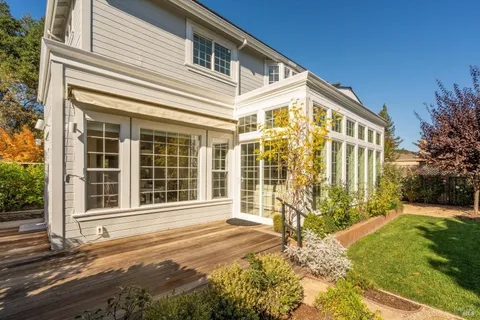 a backyard of a house with lots of green space and outdoor seating