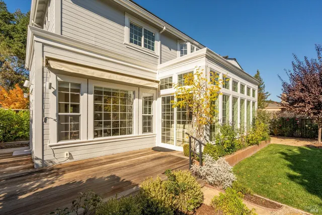 a backyard of a house with lots of green space and outdoor seating