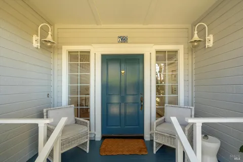 a view of front door and porch with wooden floor