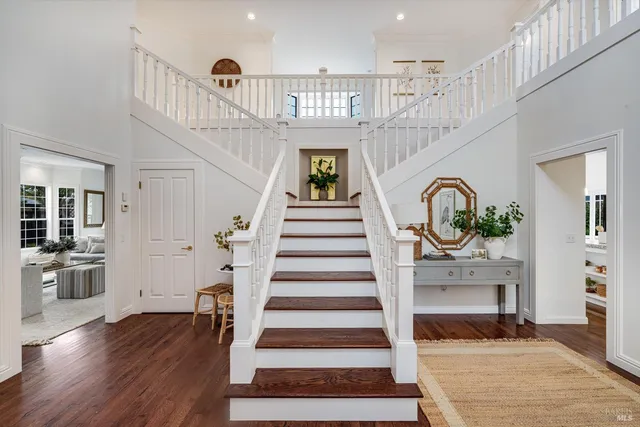 a view of entryway and hall with wooden floor