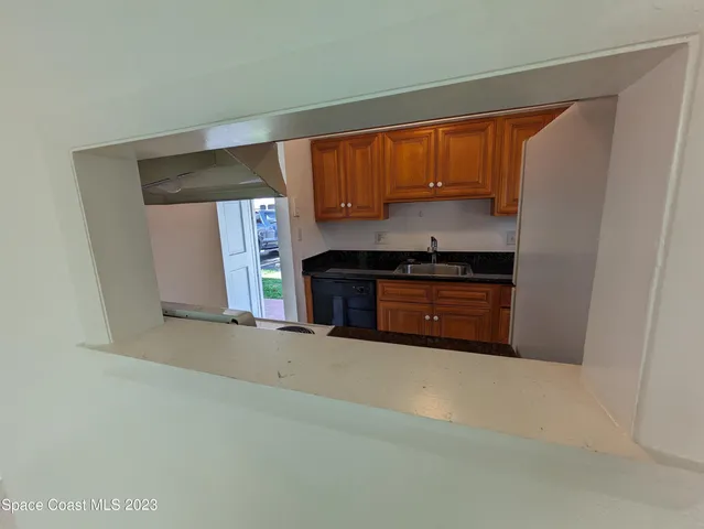 a kitchen with granite countertop a stove and cabinets