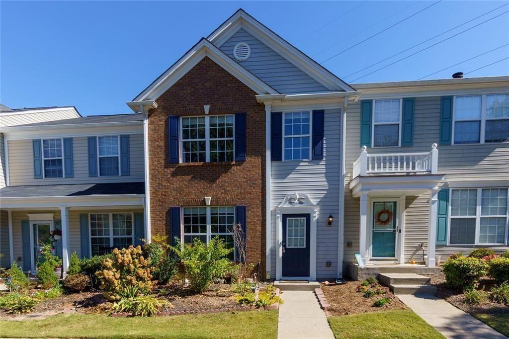 a front view of a house with yard and porch