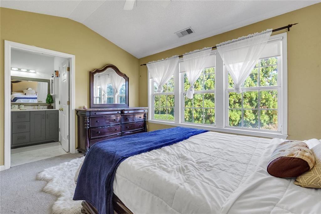 13300 Morris Road, Unit 4 Alpharetta, GA 30004 - Photo 16 of 36 a spacious bedroom with a bed and large windows