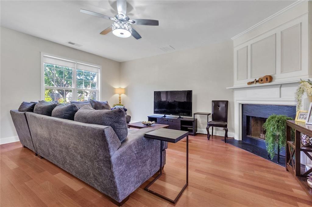 13300 Morris Road, Unit 4 Alpharetta, GA 30004 - Photo 6 of 36 a living room with furniture a fireplace and a flat screen tv
