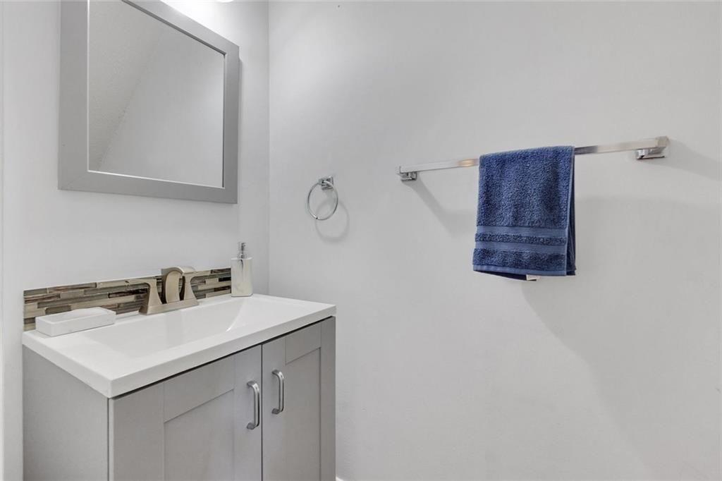 13300 Morris Road, Unit 4 Alpharetta, GA 30004 - Photo 8 of 36 a bathroom with a sink and a mirror