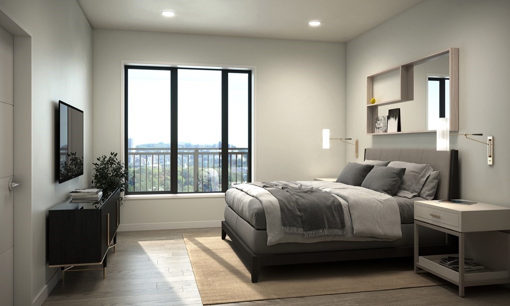 30 Penniman Road, Unit 305 Boston, MA 02134 - Photo 5 of 9 a bedroom with a bed and a large window