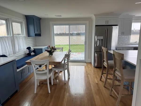 a dining room with furniture and wooden floor
