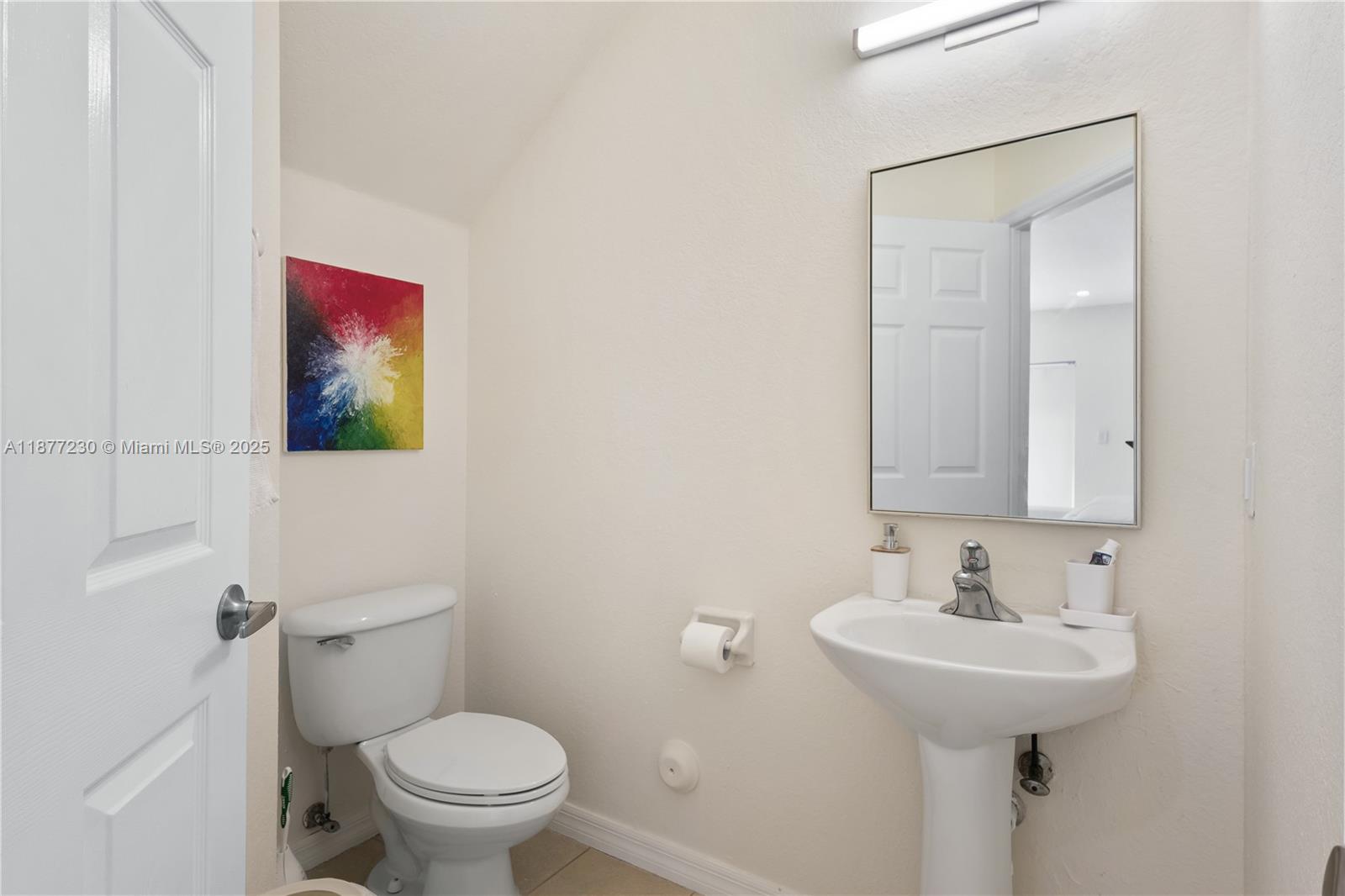 16256 Southwest 57th Lane Miami, FL 33193 - Photo 14 of 32 a bathroom with a sink toilet and a mirror