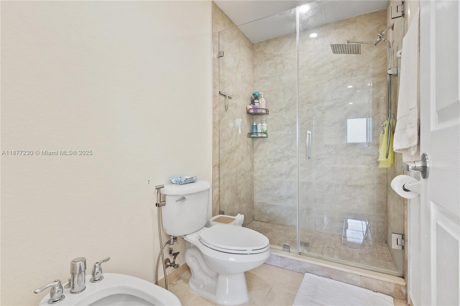 16256 Southwest 57th Lane Miami, FL 33193 - Photo 23 of 32 a bathroom with a toilet sink and shower