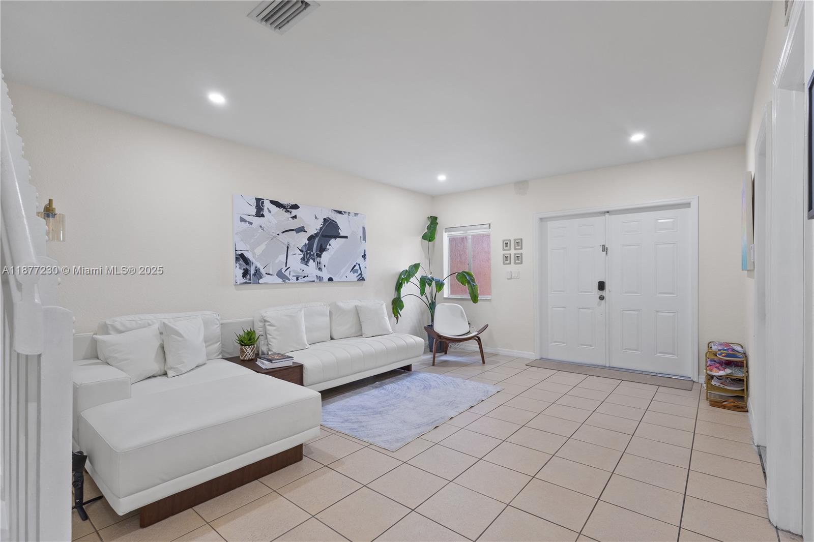 16256 Southwest 57th Lane Miami, FL 33193 - Photo 7 of 32 a spacious bedroom with a bed and a couch