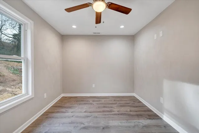 wooden floor in an empty room with a window