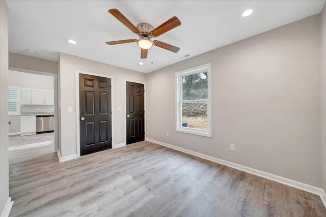 a bathroom with a granite countertop sink a toilet and a mirror
