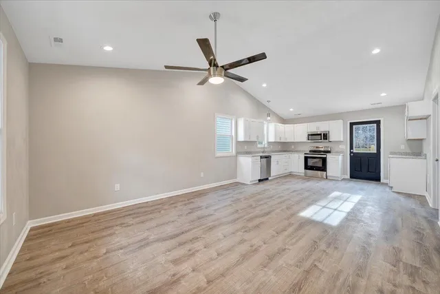 a view of a kitchen with a sink and refrigerator