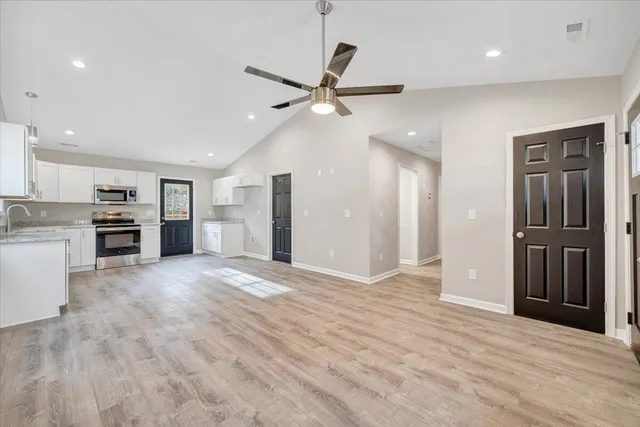 a kitchen with white cabinets and stainless steel appliances