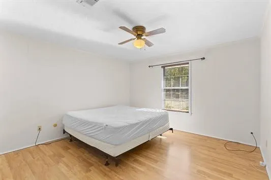 a bedroom with a bed and window