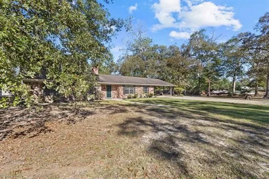 a view of a house with a tree in the background