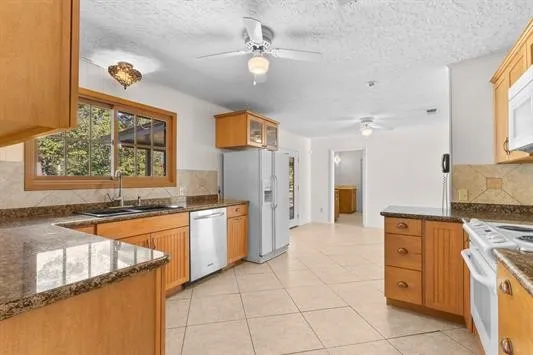 a kitchen with stainless steel appliances granite countertop a stove and a refrigerator