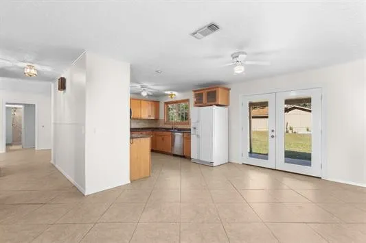 a view of a kitchen with a sink and refrigerator