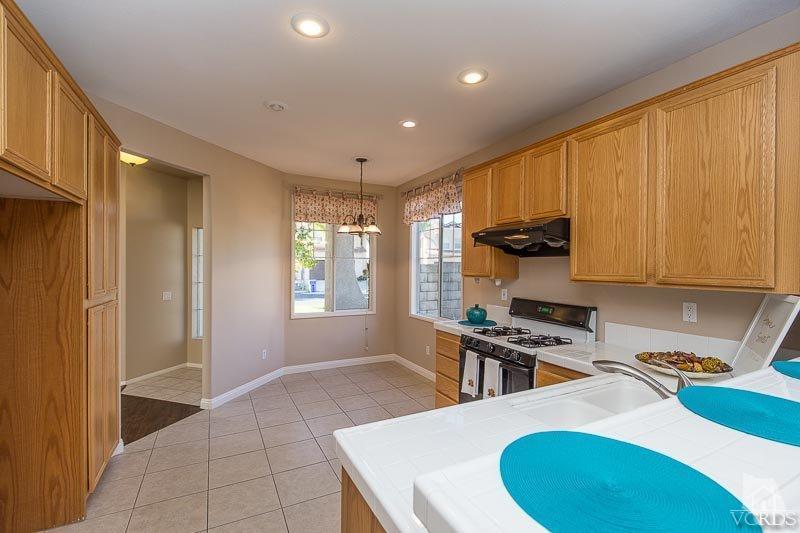 524 Shadow Lane Simi Valley, CA 93065 - Photo 8 of 40 a kitchen with stainless steel appliances a sink a stove a refrigerator cabinets and a window