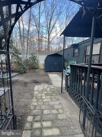 a view of a patio with table and chairs with wooden fence and plants