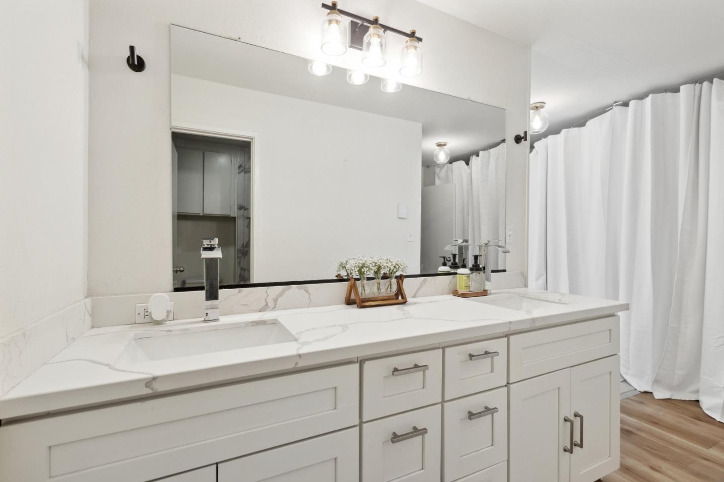 505 Cypress Point Drive, Unit 231 Mountain View, CA 94043 - Photo 2 of 17 a bathroom with double sink and a mirror