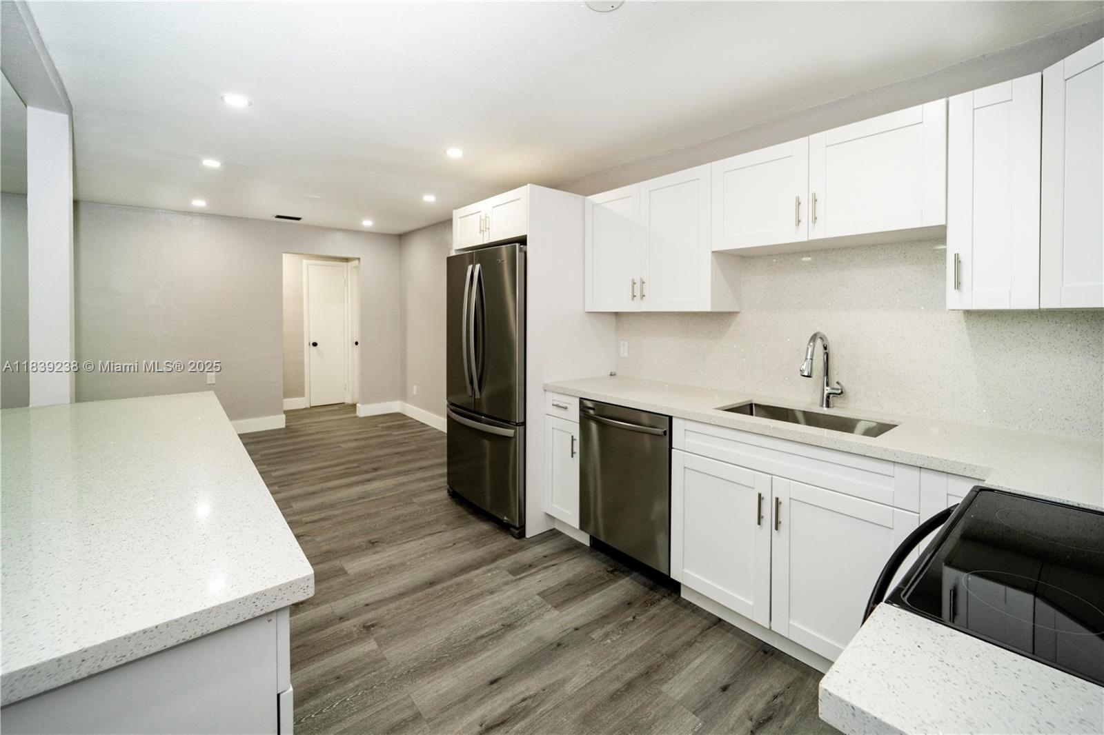 6990 Southwest 28th Street Miramar, FL 33023 - Photo 11 of 33 a kitchen with a sink a refrigerator and cabinets