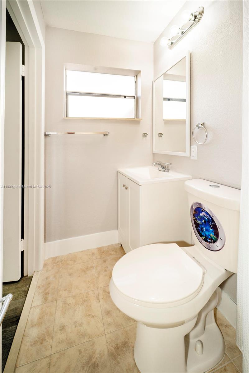 6990 Southwest 28th Street Miramar, FL 33023 - Photo 12 of 33 a bathroom with a sink a toilet and a mirror