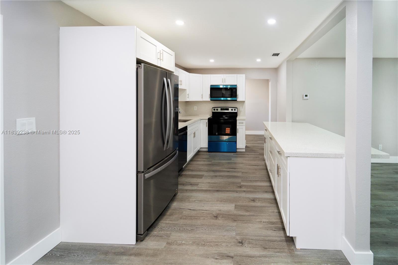 6990 Southwest 28th Street Miramar, FL 33023 - Photo 15 of 33 a kitchen with refrigerator and car