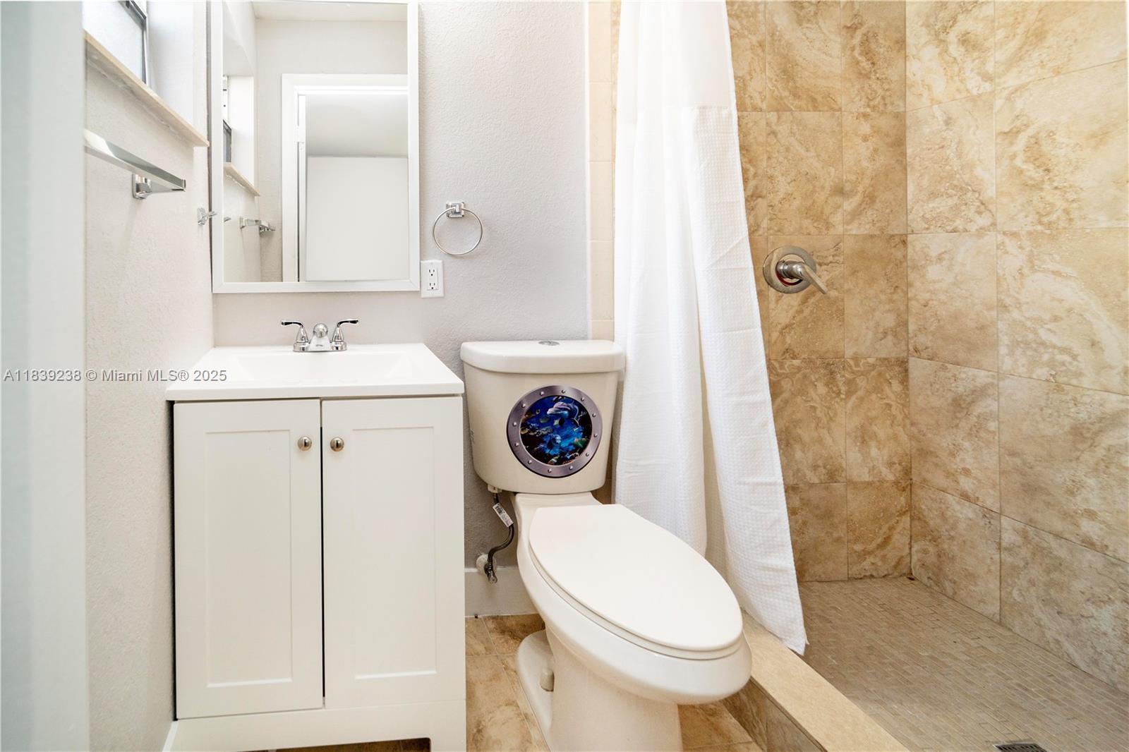 6990 Southwest 28th Street Miramar, FL 33023 - Photo 17 of 33 a bathroom with a sink a toilet and a mirror