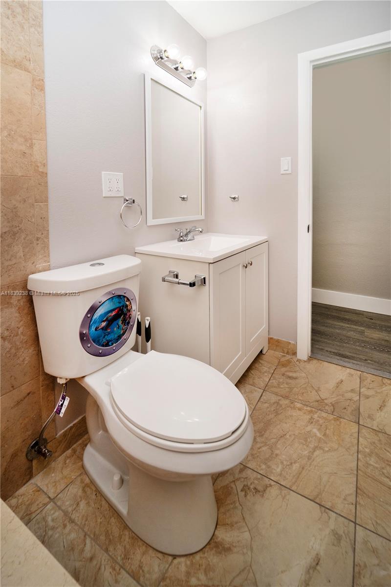 6990 Southwest 28th Street Miramar, FL 33023 - Photo 21 of 33 a bathroom with a sink toilet and a mirror
